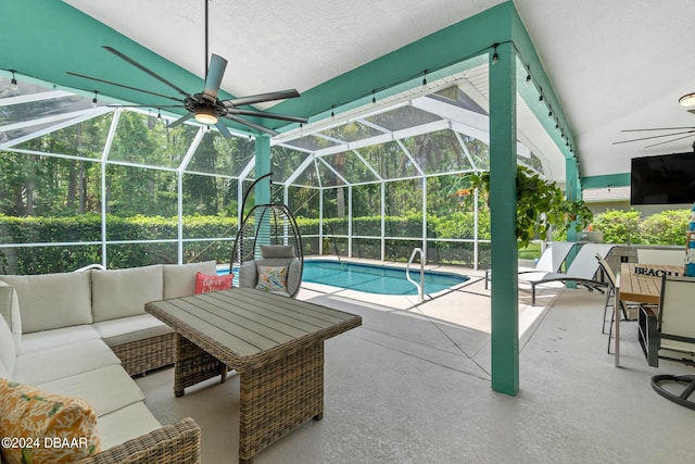 view of pool featuring a patio area, ceiling fan, glass enclosure, and outdoor lounge area