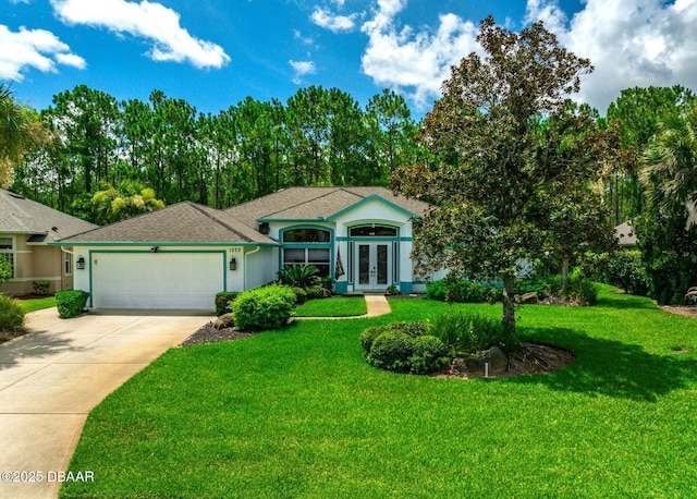 single story home featuring french doors, a front lawn, and a garage