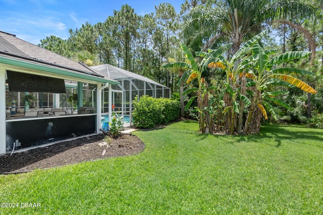 view of yard with glass enclosure