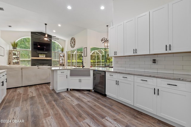 kitchen featuring vaulted ceiling, tasteful backsplash, white cabinets, ceiling fan, and black dishwasher