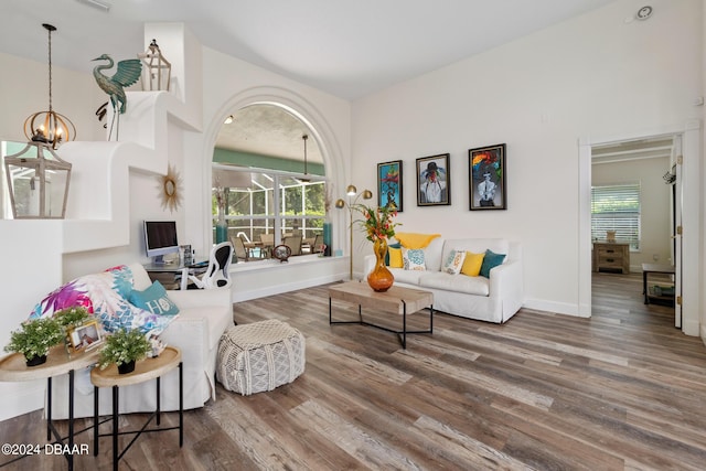 living room featuring an inviting chandelier and wood-type flooring