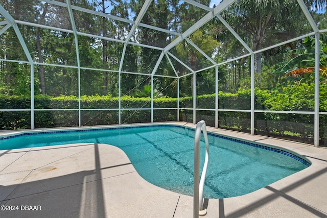 view of swimming pool with a patio and glass enclosure