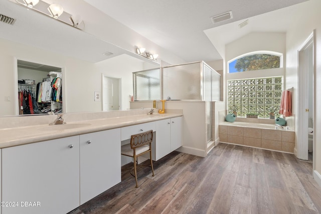 bathroom featuring shower with separate bathtub, wood-type flooring, and vanity