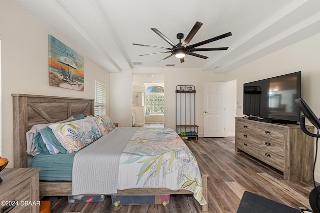 bedroom featuring ceiling fan, dark wood-type flooring, and ensuite bathroom