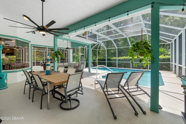 view of patio featuring ceiling fan and a lanai