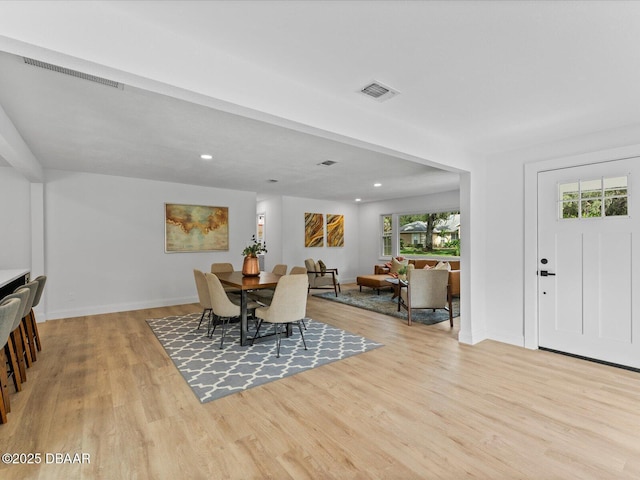 dining room featuring visible vents, a healthy amount of sunlight, and light wood finished floors