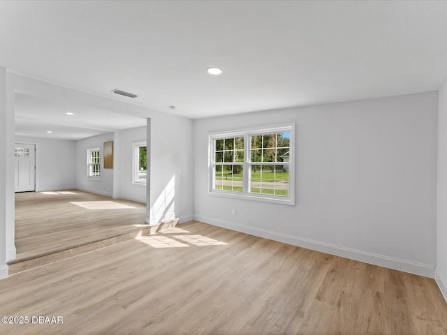 empty room featuring visible vents, recessed lighting, baseboards, and light wood-style floors