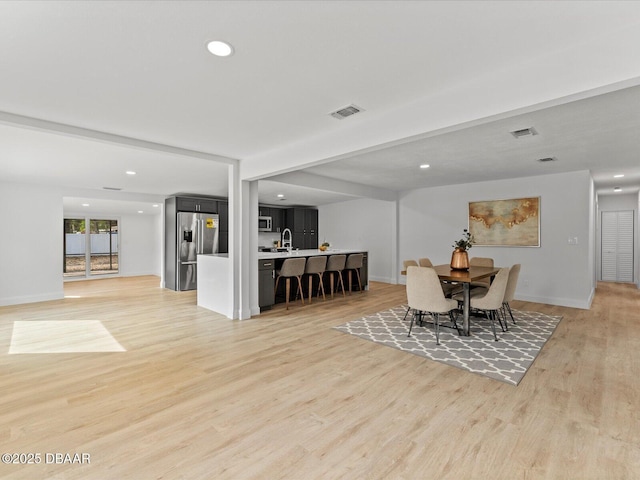 dining space with recessed lighting, visible vents, and light wood-style floors