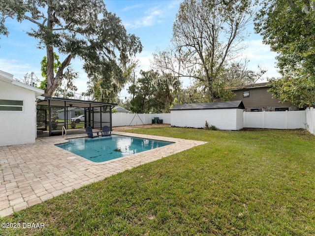 view of swimming pool with a fenced backyard, a lawn, a patio, and a sunroom