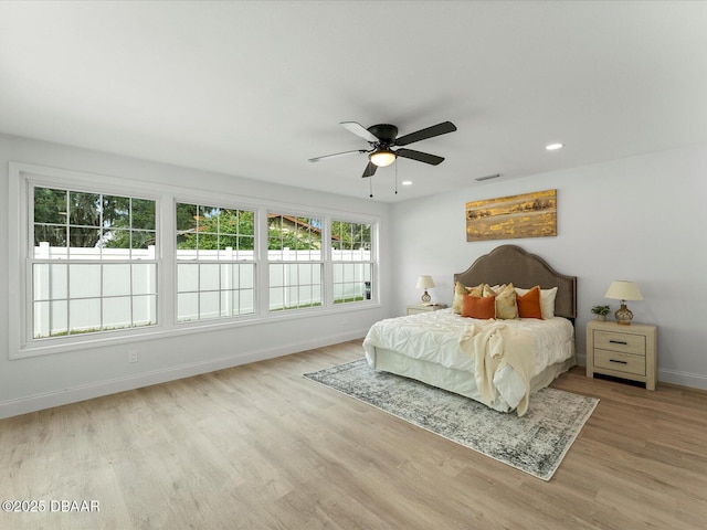bedroom featuring a ceiling fan, visible vents, wood finished floors, baseboards, and recessed lighting