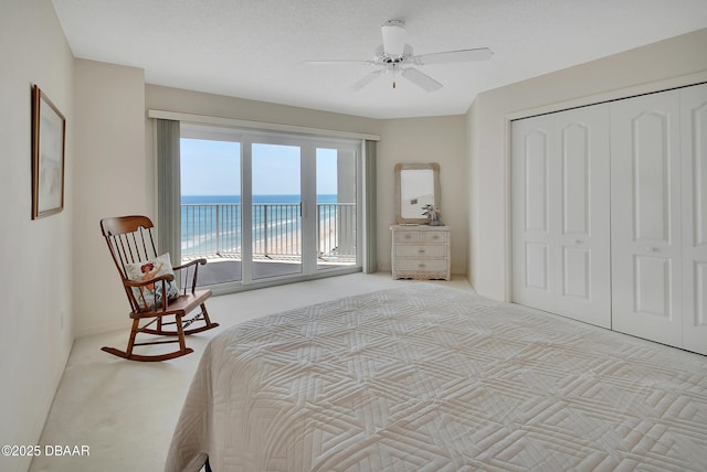 2937 S Atlantic Ave Unit 1108, Daytona Beach Shores, FL 32118 - carpeted bedroom featuring access to exterior, a water view, a closet, and ceiling fan
