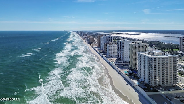 drone / aerial view featuring a beach view and a water view