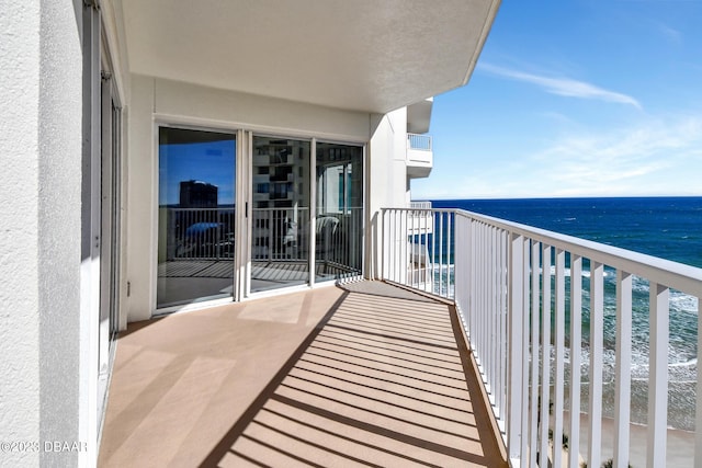 balcony with a water view and an AC wall unit