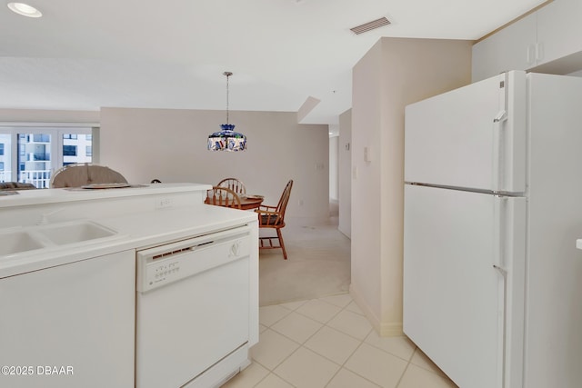 2937 S Atlantic Ave Unit 1108, Daytona Beach Shores, FL 32118 - kitchen featuring white appliances, light colored carpet, decorative light fixtures, light countertops, and a sink
