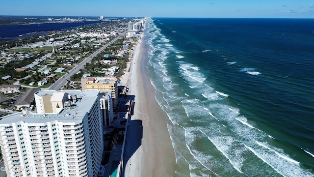 birds eye view of property with a water view and a view of the beach