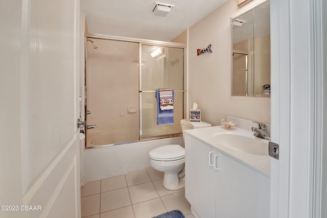 full bathroom featuring tile patterned flooring, shower / bath combination with glass door, toilet, and vanity