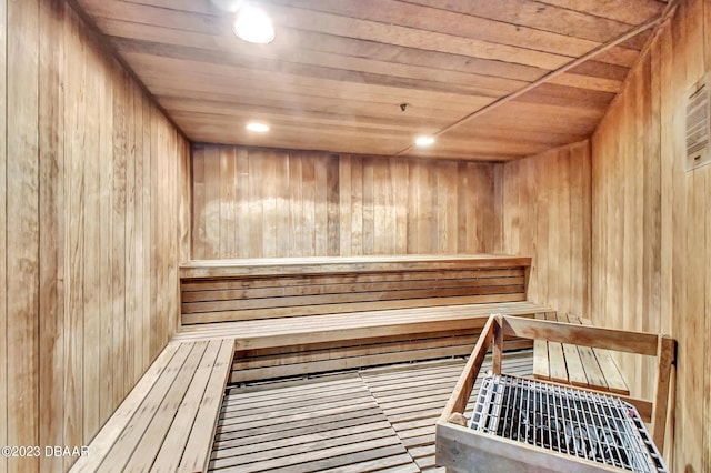 view of sauna with wood walls and wood ceiling