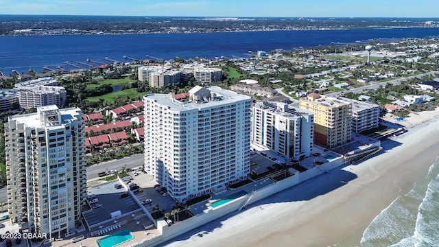 drone / aerial view featuring a beach view and a water view