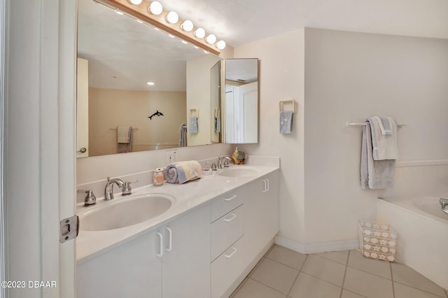 bathroom featuring vanity, tile patterned floors, and a bathing tub