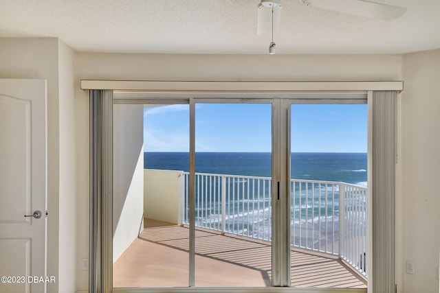 doorway with a textured ceiling and a water view