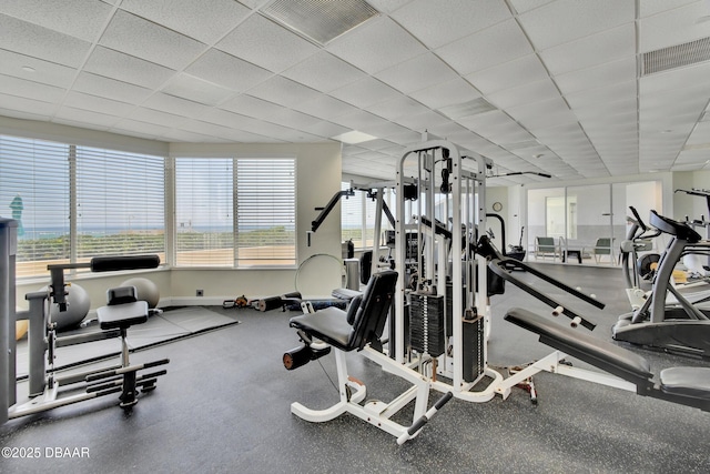 2937 S Atlantic Ave Unit 1108, Daytona Beach Shores, FL 32118 - workout area with healthy amount of natural light, a paneled ceiling, and baseboards