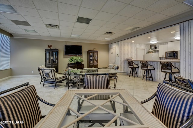 tiled living room with a drop ceiling