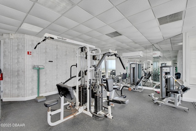 2937 S Atlantic Ave Unit 1108, Daytona Beach Shores, FL 32118 - workout area with a wall mounted AC, baseboards, and a drop ceiling