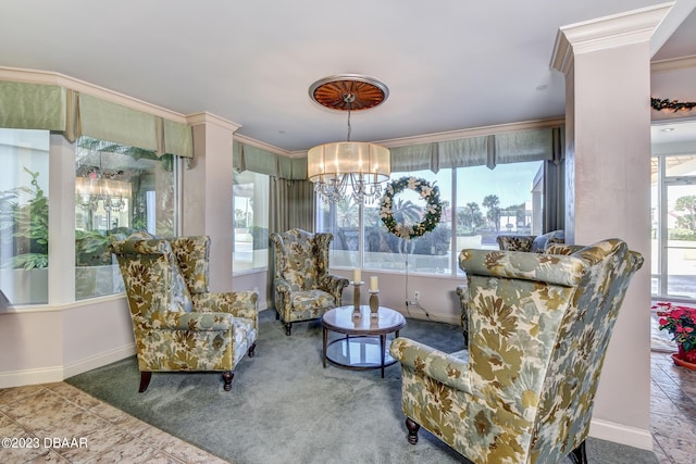 living area featuring ornamental molding and a chandelier