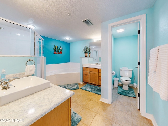 full bathroom with tile patterned floors, vanity, a textured ceiling, separate shower and tub, and toilet