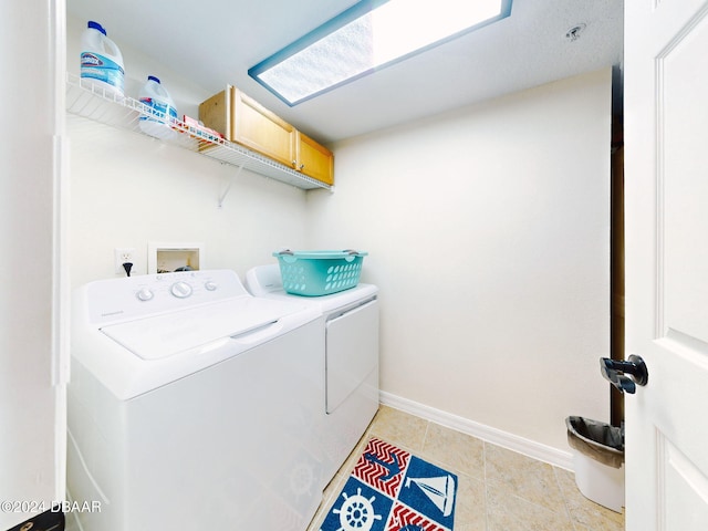 washroom with separate washer and dryer and light tile patterned floors