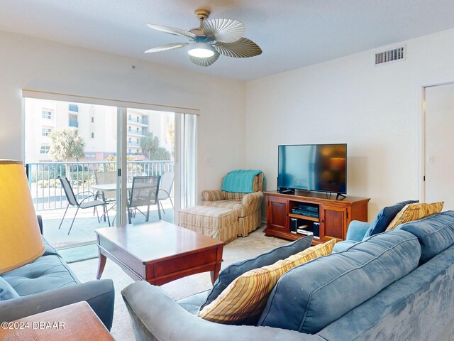 carpeted living room featuring ceiling fan