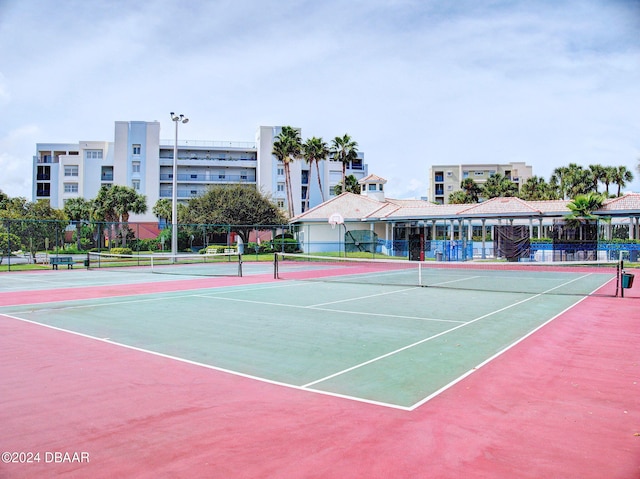 view of tennis court featuring basketball hoop