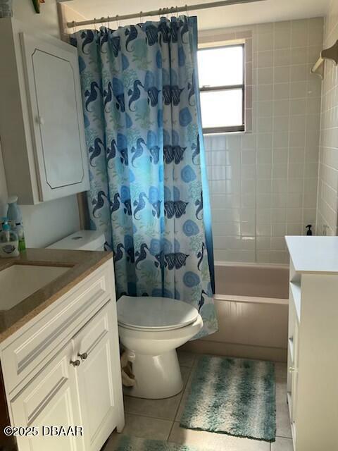 full bathroom with toilet, shower / tub combo, tile patterned flooring, and vanity