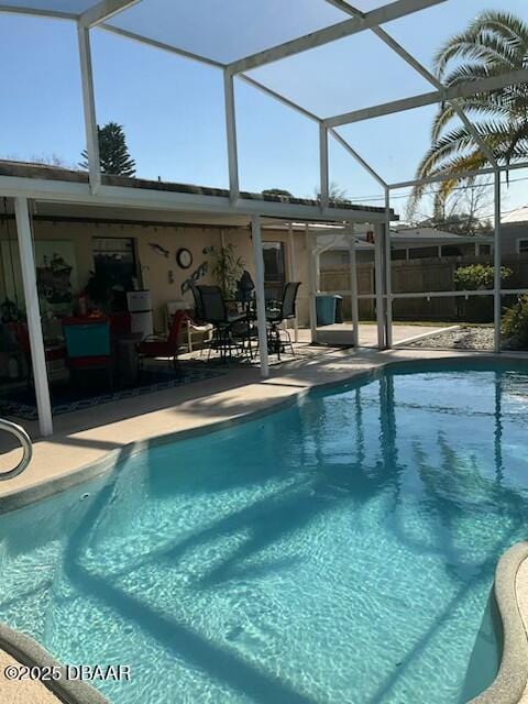 view of swimming pool with a patio area and glass enclosure