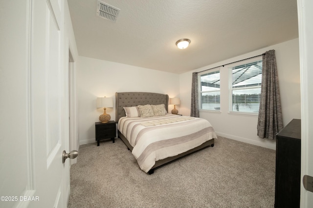 bedroom featuring baseboards, visible vents, a textured ceiling, and light colored carpet