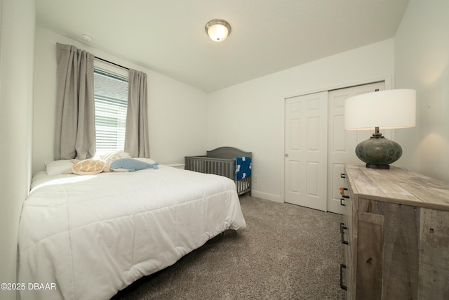 carpeted bedroom with a closet and baseboards