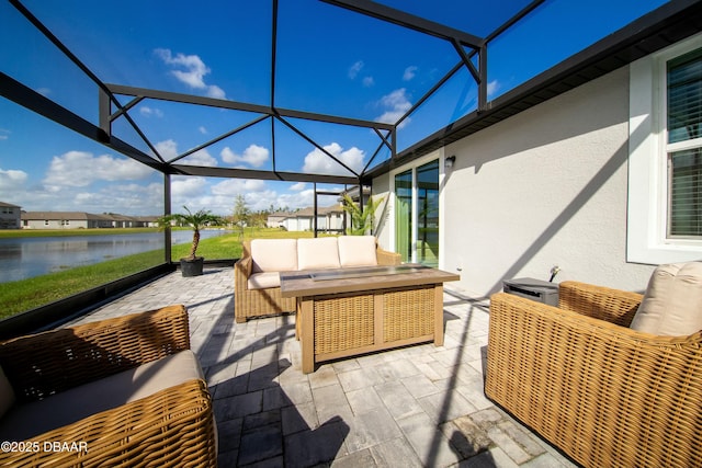 view of patio / terrace with glass enclosure, outdoor lounge area, and a water view