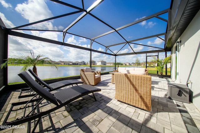 view of patio / terrace with a lanai, a water view, and an outdoor hangout area