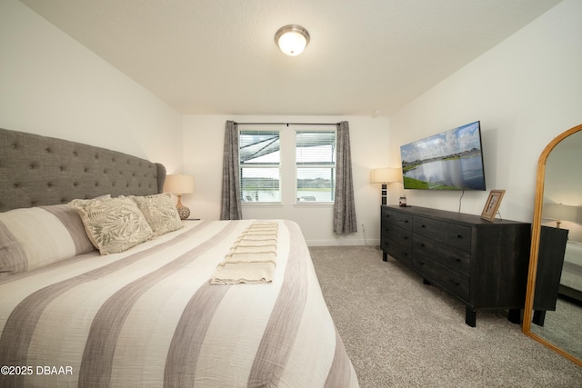 carpeted bedroom featuring baseboards