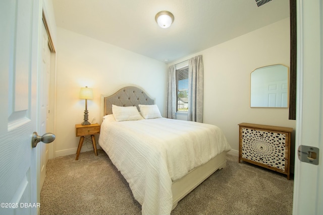 carpeted bedroom with visible vents and baseboards