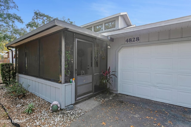 view of front facade featuring a sunroom and a garage