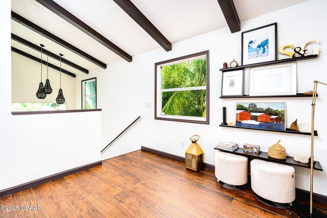 3110 John Anderson Dr, Ormond Beach, FL 32176 - sitting room with lofted ceiling with beams and hardwood / wood-style floors