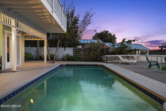 3110 John Anderson Dr, Ormond Beach, FL 32176 - pool at dusk featuring a deck