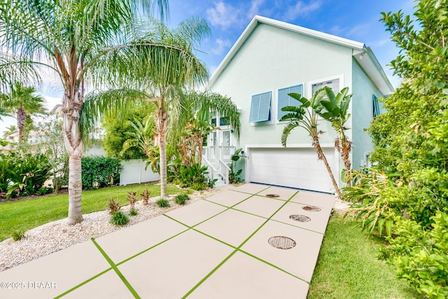 3110 John Anderson Dr, Ormond Beach, FL 32176 - view of front facade with a garage and a front yard