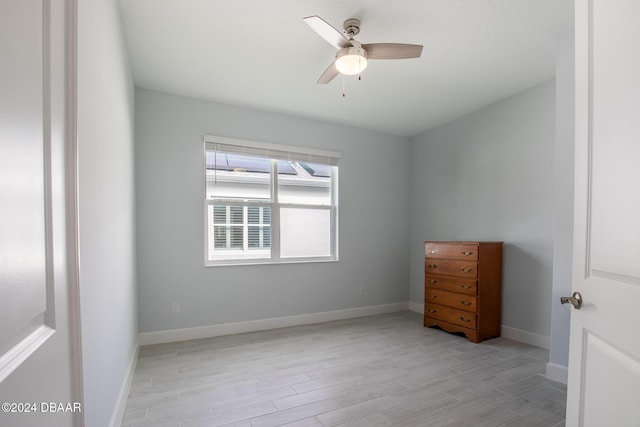 unfurnished room with light wood-type flooring and ceiling fan