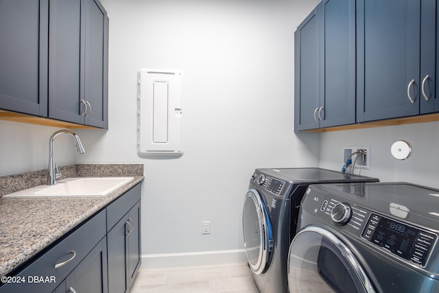 laundry room with cabinets, electric panel, washer and clothes dryer, and sink