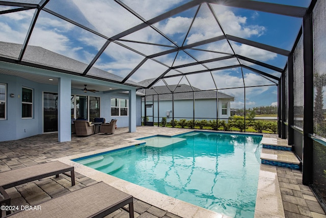 view of swimming pool featuring a patio area, a lanai, and ceiling fan