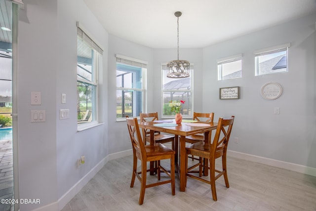 dining room with an inviting chandelier and light hardwood / wood-style floors