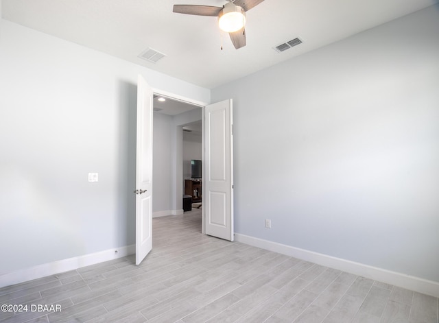 unfurnished room with ceiling fan and light hardwood / wood-style floors