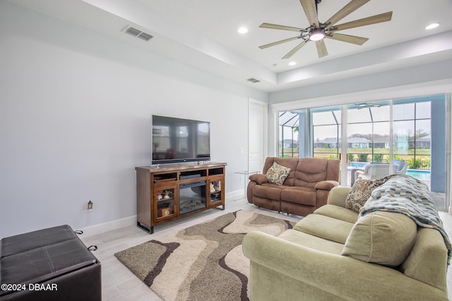 living room with ceiling fan and light hardwood / wood-style floors